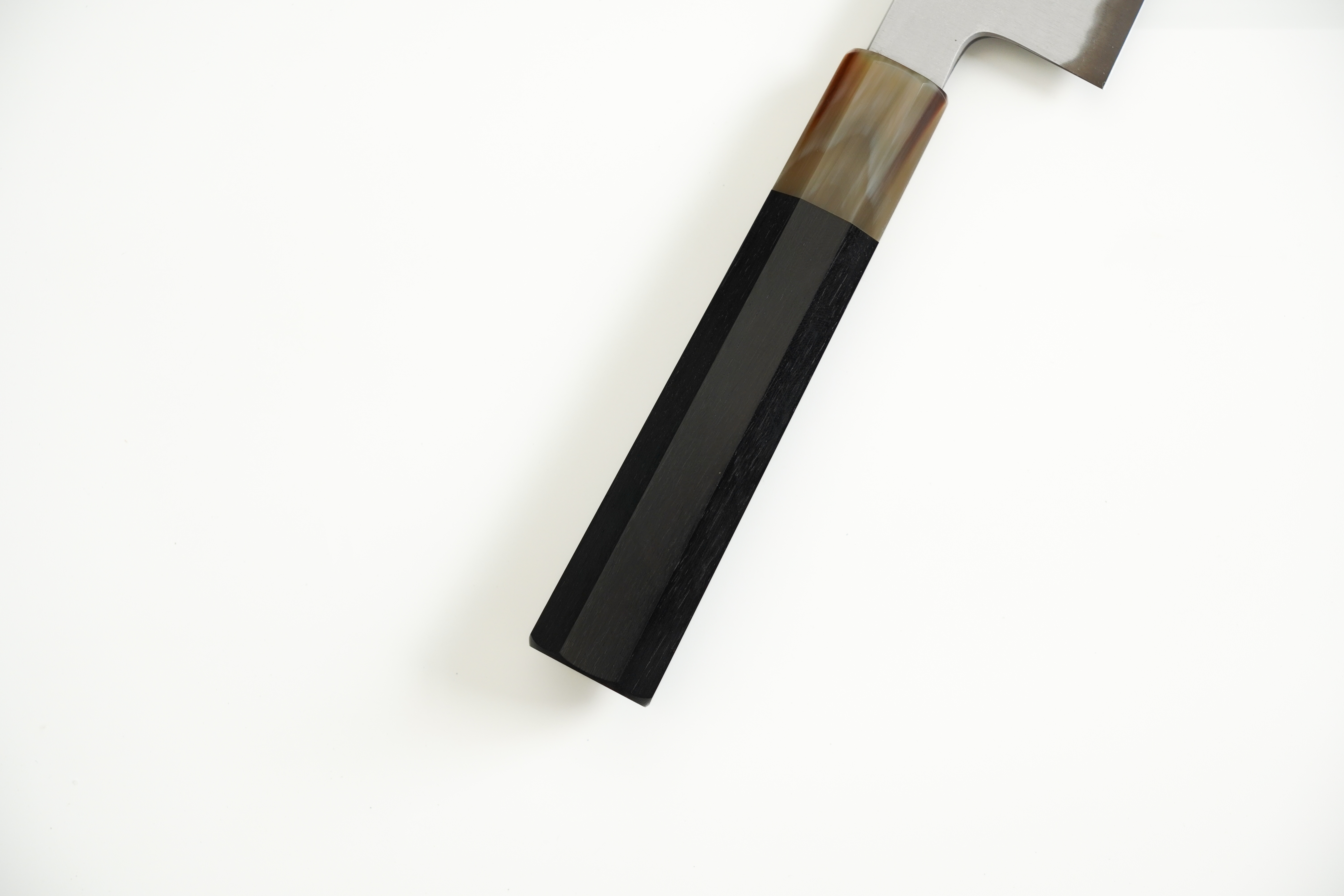 Dark ebony with white buffalo horn ferrule